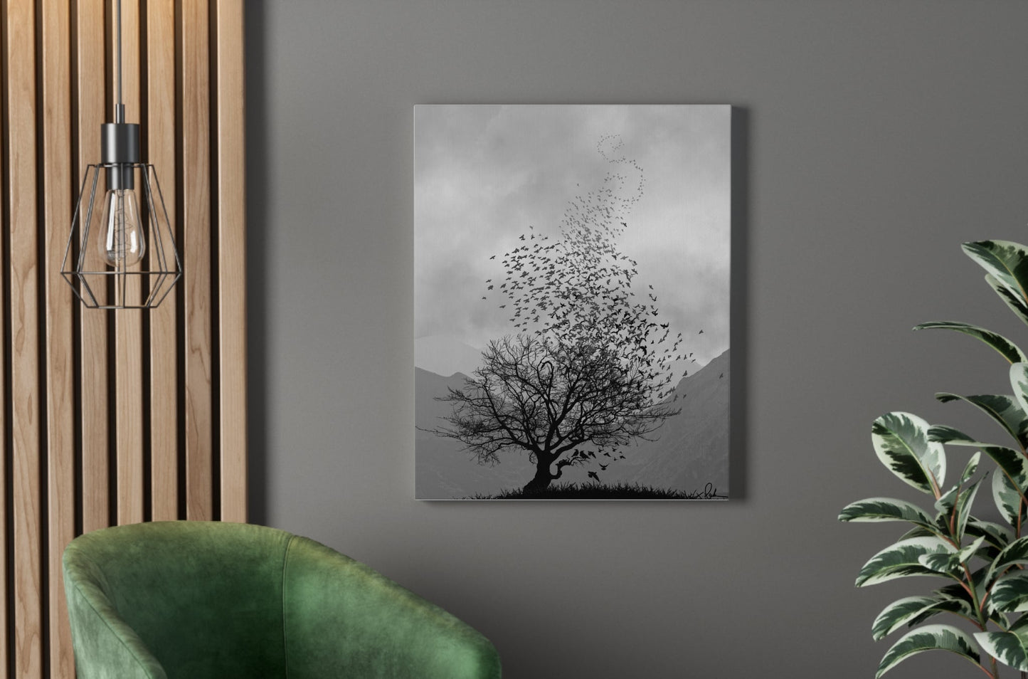 Green armchair in a room with a wall painting of a tree and birds, a plant, and a pendant light.