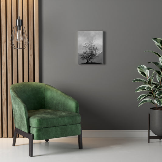 Green armchair in a room with a gray wall, and a plant - showing the Grey Valley Tree canvas art print on the wall