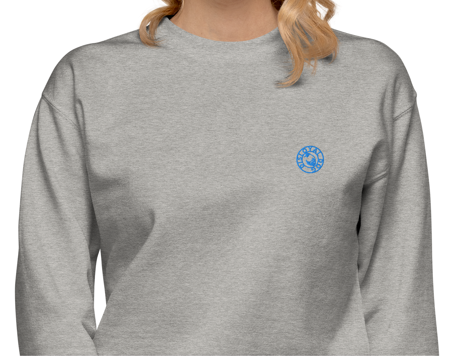 Woman wearing a light gray sweatshirt with a light blue Disloyal Dog logo on the left side of the chest.